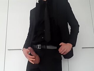 Man in suit masturbates